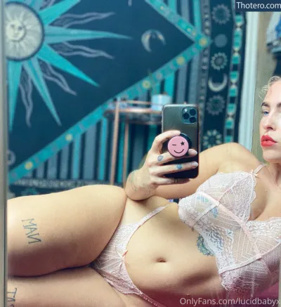 lucidbabyx - blonde woman in lingerie taking a selfie with her cell phone