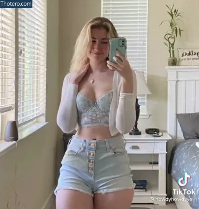 Sydney Sheridan - blond woman in a bra top and denim shorts taking a selfie