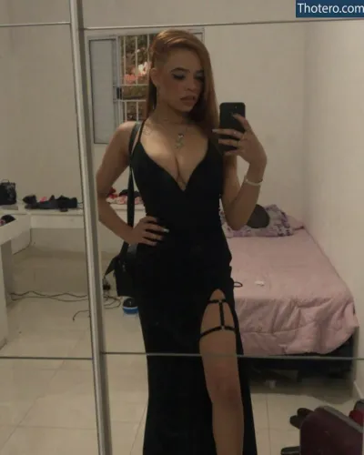 Natália Gomes - woman in a black dress taking a selfie in a mirror