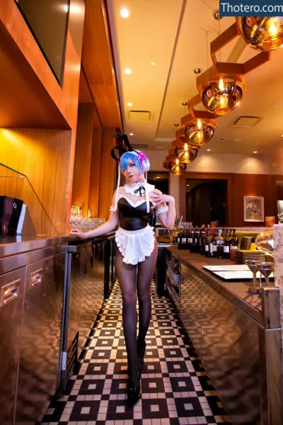 Vicky Lau - there is a woman in a sexy outfit standing in a restaurant