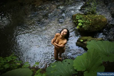 Little Cookie - woman standing in a stream with a leaf in her hand