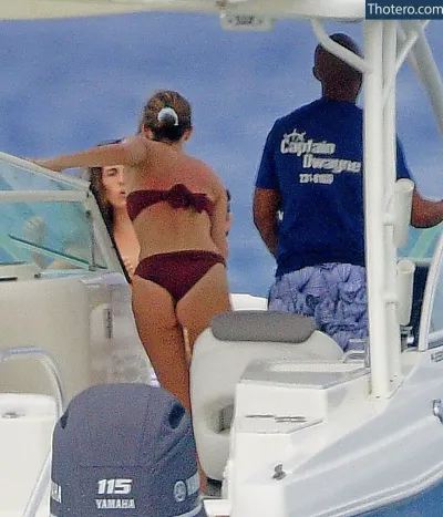 Emma Watson - woman in a bikini on a boat with a man standing next to her