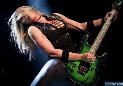 WomenMetal - woman with a green guitar on stage with a microphone