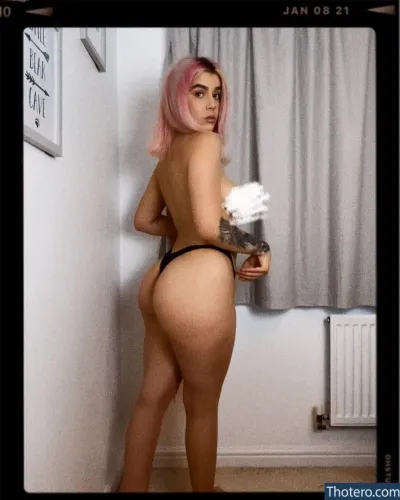 Ffion Holly James - woman with pink hair and a black thong on standing in a room