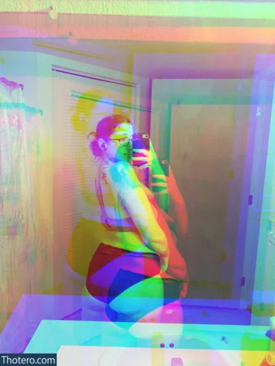 bxttplugs666 - brightly colored photograph of a woman taking a picture of herself in a mirror