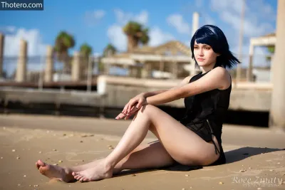 Emily_Cos - woman sitting on the beach with her legs crossed