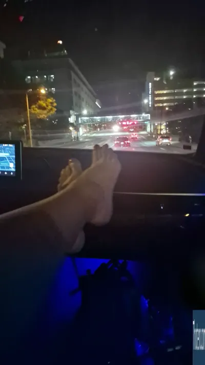 Grimoire - someone is driving a car at night with their feet on the dashboard