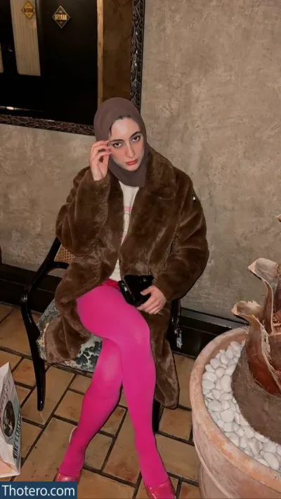 Sher Arar - woman in a pink tights and a brown coat