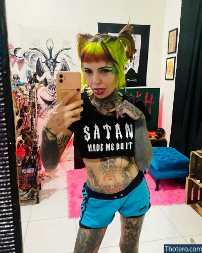 Mari Zombie - tattooed woman taking a selfie in a mirror with a cell phone