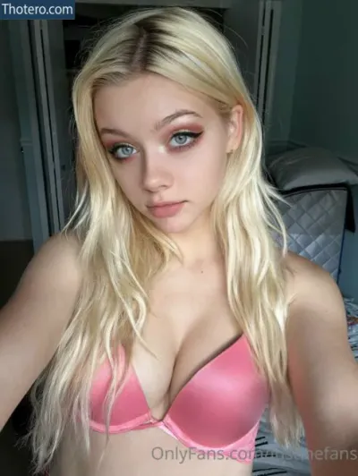 Justine Paradise - a close up of a woman in a pink bra top