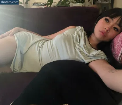 Radvxz - woman laying on a couch with a cat on her lap