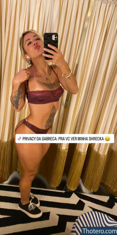 gabreca - woman in a bikini taking a selfie in a mirror