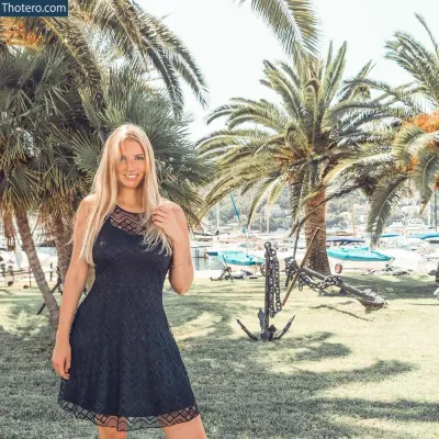 Melissamelody - woman in a black dress standing in a park