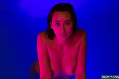 AlexiaOnMFC - woman sitting on a stool in a blue room