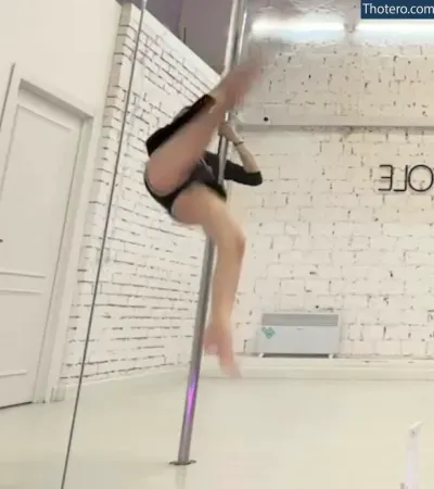 Fasoollka - pole dancing in a white room with a brick wall