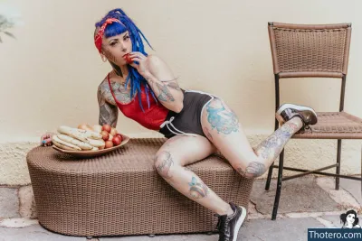 naypi - woman with blue hair sitting on a bench with a plate of food