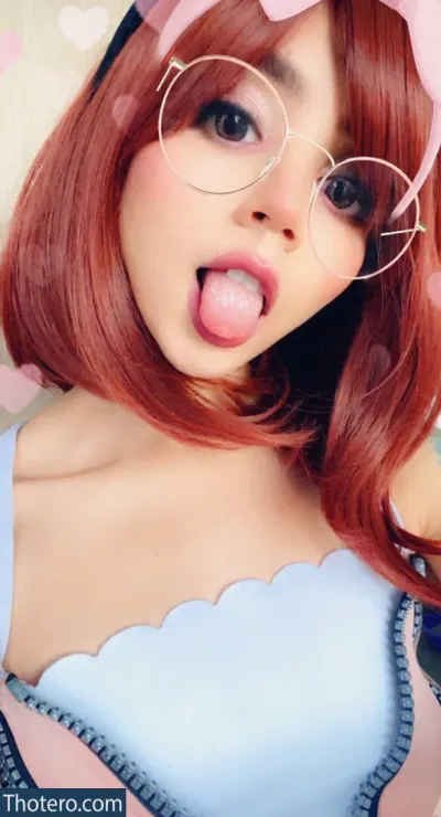 Valkitty_kitty - a close up of a woman with a pink bow and glasses