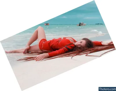 Rachel Marie - there is a woman laying on the beach with her legs crossed