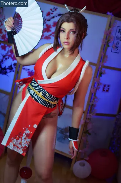 Shermie Cosplay - asian woman in a red and white outfit holding a fan