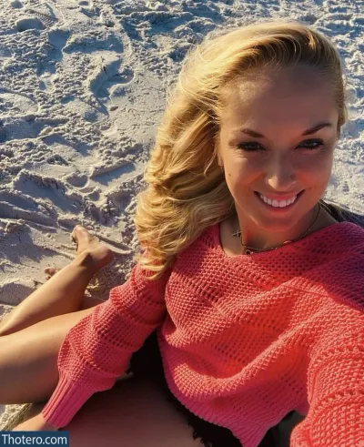 Sabine Lisicki - woman sitting on the beach with a cell phone in her hand