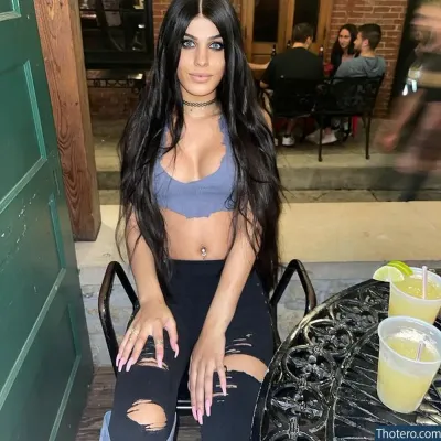 Juliebunny69 - woman sitting on a chair with a drink in front of her