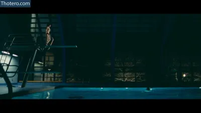 Zooey Deschanel - a close up of a person standing on a diving board in a pool