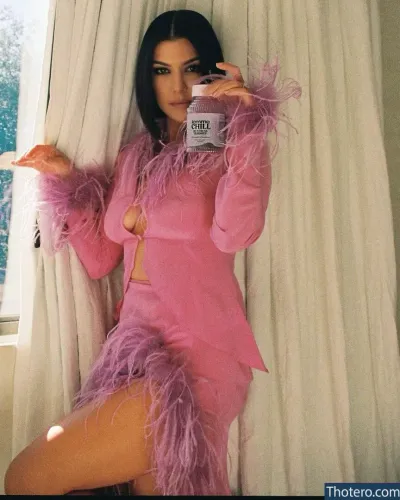 Kourtney Kardashian - woman in a pink dress holding a cup of coffee