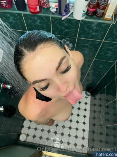 Kylie Sudgen - woman with a wet head sticking out of a shower