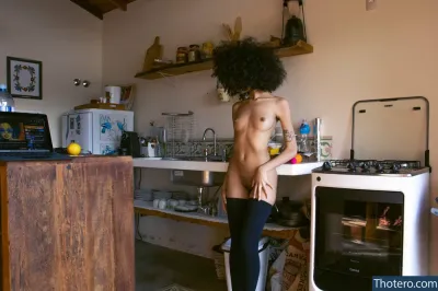 msflat - there is a naked woman standing in a kitchen with a stove