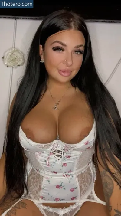 Sammy - a woman with long black hair and a white bra top