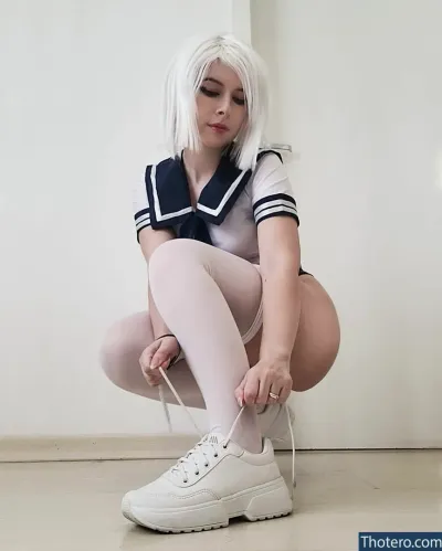 Pocket.neko - woman in a sailor outfit tying up her white sneakers