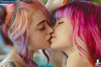 Mimo - there are two girls with pink hair and blue eyes kissing