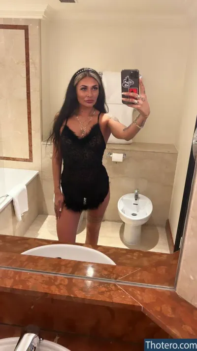 Tyler Jo Walker - woman taking a selfie in a bathroom mirror with a phone