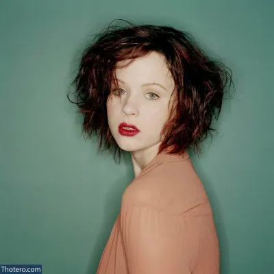 Thora Birch - woman with red lipstick and a brown shirt