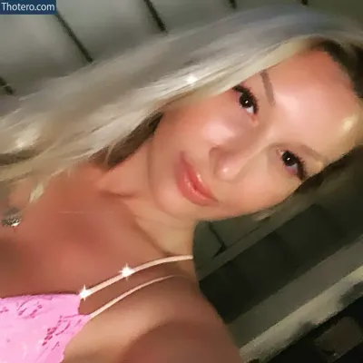 Lacey Denae - blond woman in pink bra top posing for a selfie