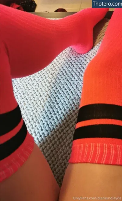 Diamond Ayleks - a close up of a person wearing pink socks and black and red socks