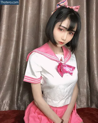 valentine8_official - there is a woman in a pink and white uniform posing for a picture