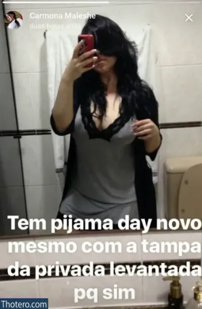 Bruna Carmona - woman taking a selfie in a bathroom mirror with a phone