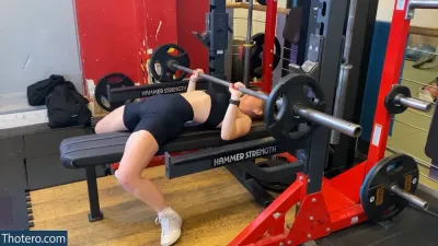 mira.004 - woman doing a bench press in a gym
