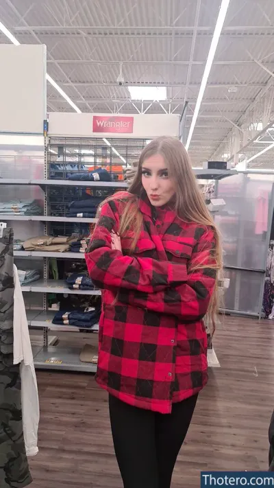 Grimoire - woman in a red and black plaid shirt standing in a store