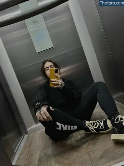 IoanaMocanu - sitting on the floor in front of a mirror taking a selfie