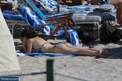 Lena Meyer-Landrut - there is a woman laying on a towel on the beach