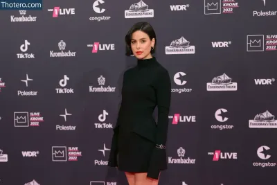 Lena Meyer-Landrut - a woman in a black dress standing on a red carpet