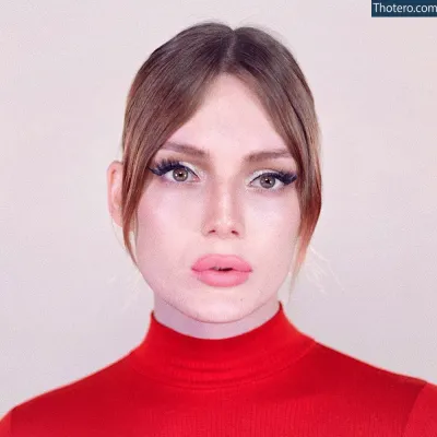 Isla Rose - image of a woman with a red turtle neck sweater