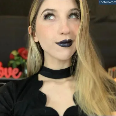 FrivolousFox ASMR - a close up of a woman with a black choke and a black top