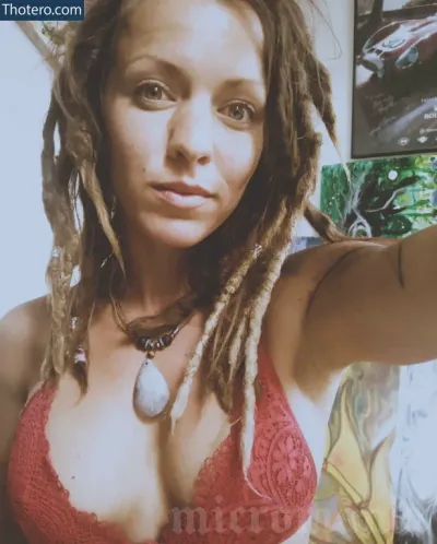 Micromandi - woman with dreads and a red bra top taking a selfie