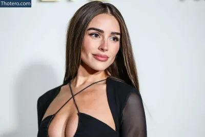Olivia Culpo - a close up of a woman in a black dress posing for a picture