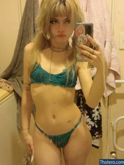 allmyheartbear - blond woman in a blue bikini taking a selfie in a bathroom