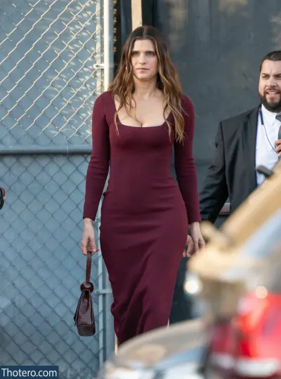 Lake Bell - woman in a maroon dress walking down a street