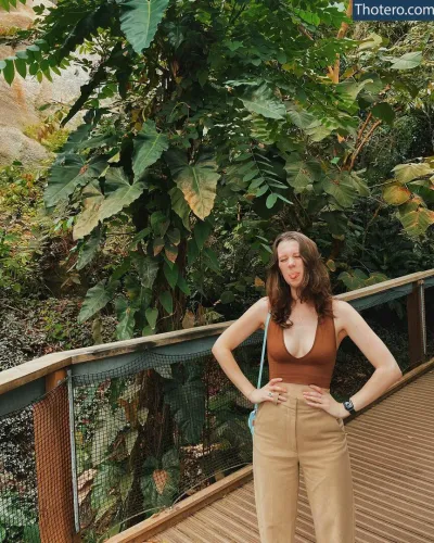 Ellbat - woman standing on a wooden walkway in a tropical area